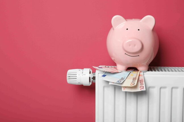 Piggy bank and money on heating radiator